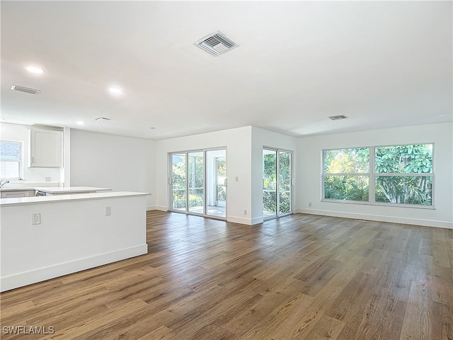 unfurnished living room with wood-type flooring