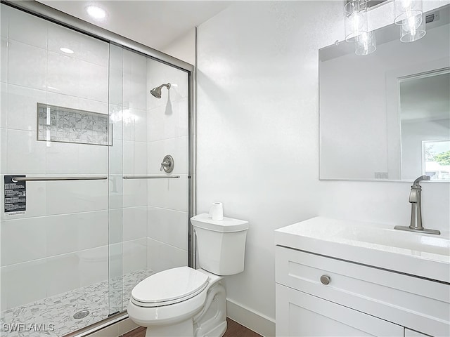 bathroom with vanity, toilet, and an enclosed shower