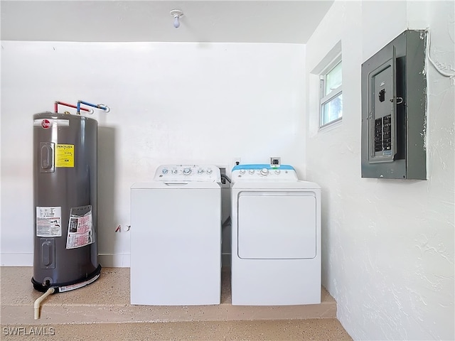 clothes washing area with electric panel, washer and dryer, and electric water heater