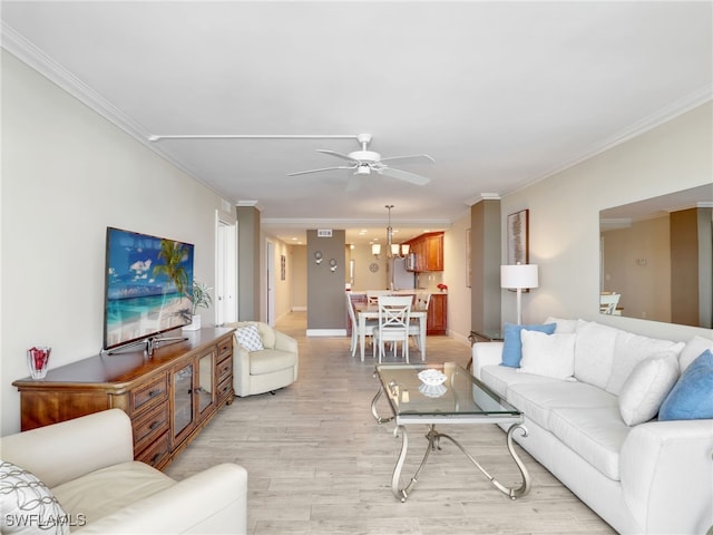 living room with crown molding, light hardwood / wood-style floors, and ceiling fan with notable chandelier