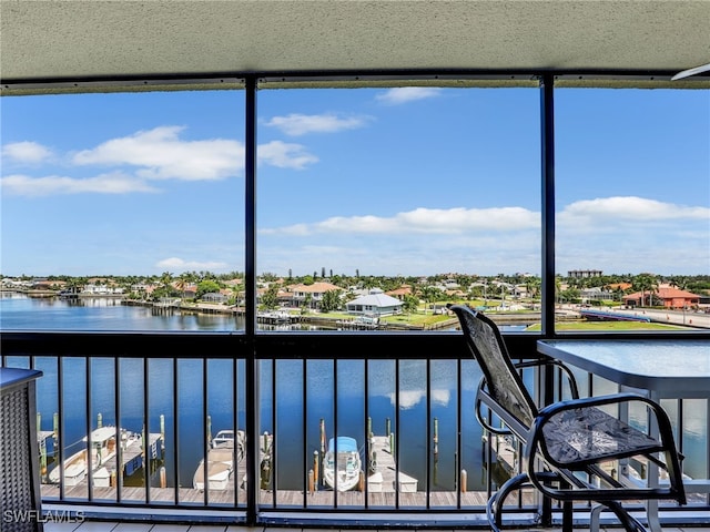 unfurnished sunroom featuring a water view