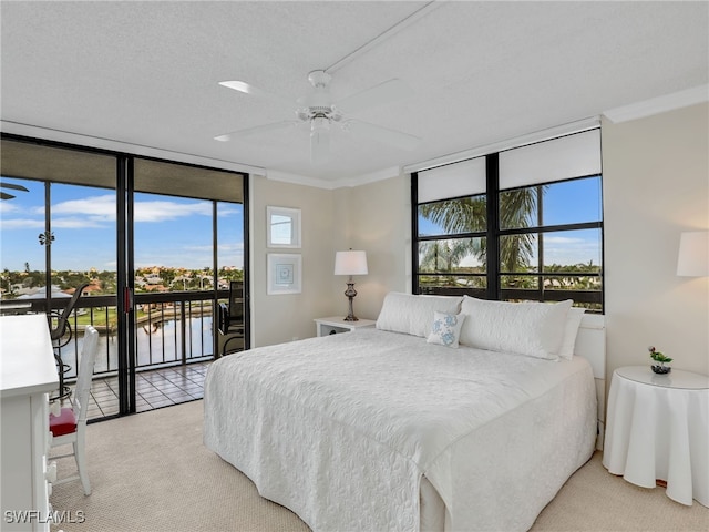 bedroom with access to outside, a water view, multiple windows, and ceiling fan