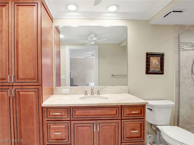 bathroom featuring ornamental molding, vanity, toilet, and ceiling fan