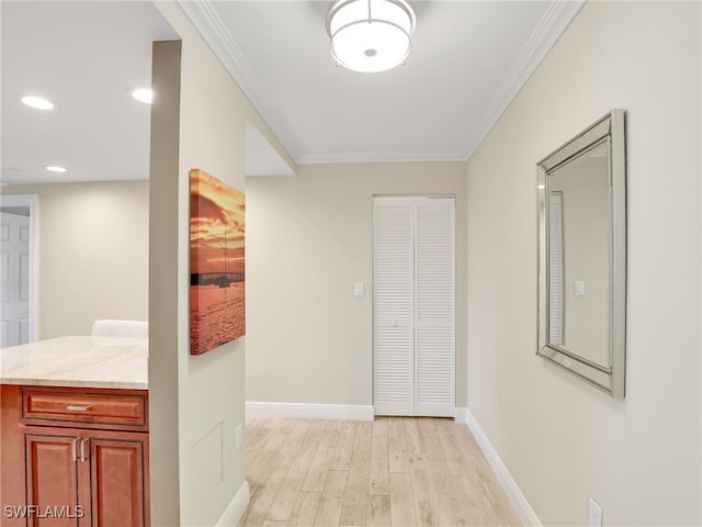 hall with ornamental molding and light wood-type flooring