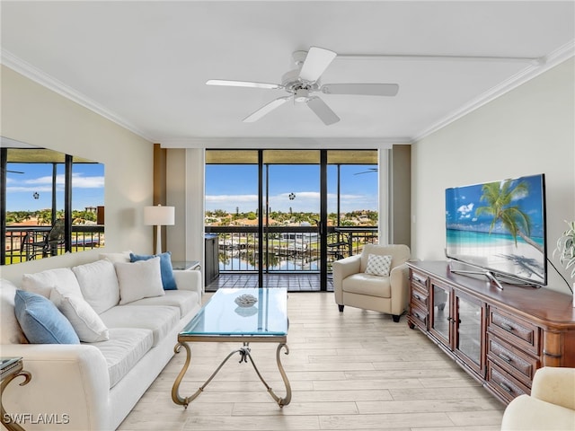 living room featuring crown molding, ceiling fan, light hardwood / wood-style flooring, and expansive windows