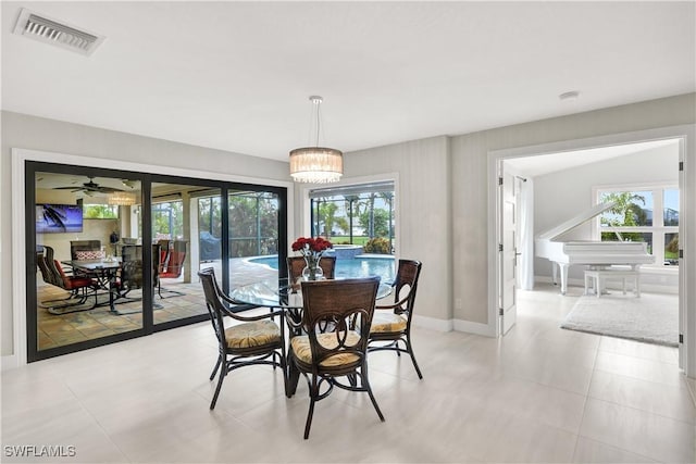 dining space with visible vents, a notable chandelier, baseboards, and light tile patterned floors