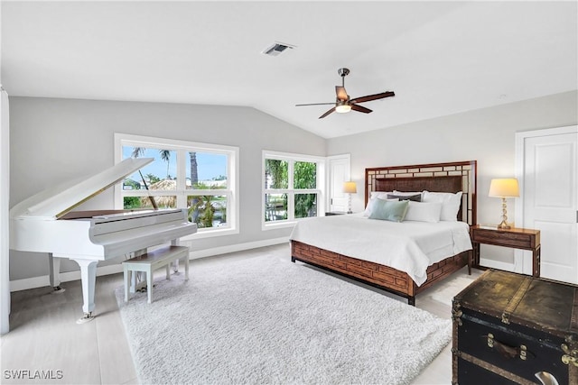 bedroom featuring lofted ceiling, baseboards, visible vents, and ceiling fan