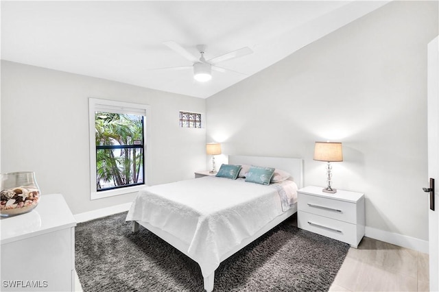 bedroom with ceiling fan and baseboards