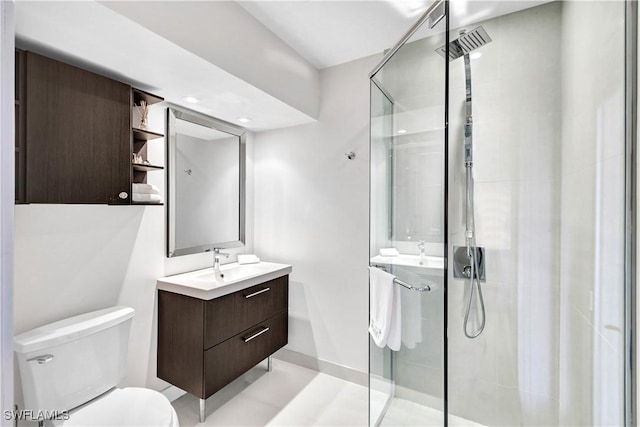 bathroom featuring baseboards, a shower stall, toilet, and vanity