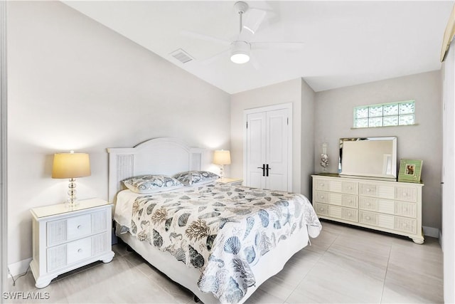 bedroom featuring a ceiling fan, a closet, visible vents, and tile patterned floors