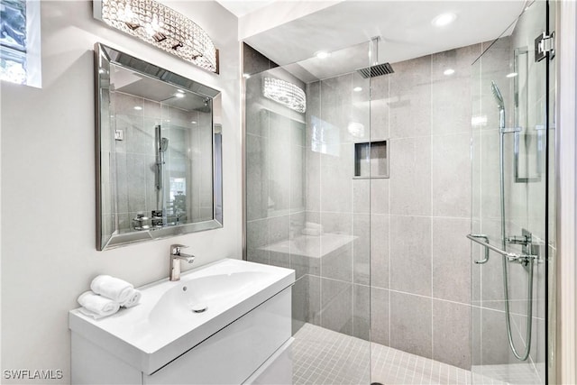 bathroom with a shower stall and vanity