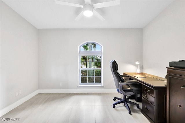 office with a ceiling fan and baseboards