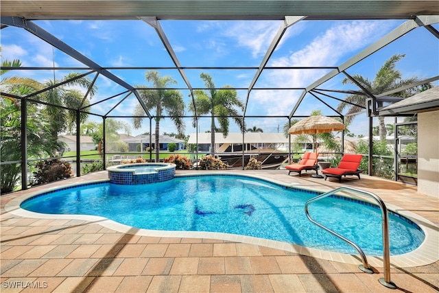 view of pool with a pool with connected hot tub, glass enclosure, and a patio