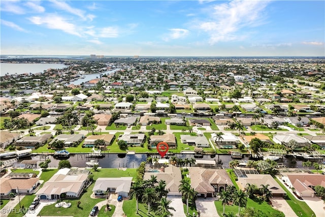 birds eye view of property featuring a water view and a residential view