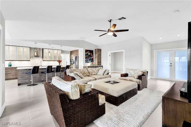 living room with visible vents, a ceiling fan, lofted ceiling, french doors, and light tile patterned flooring