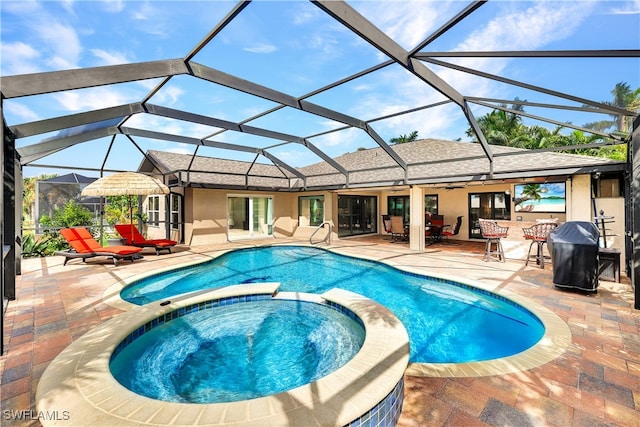 view of swimming pool with a patio, a lanai, and a pool with connected hot tub