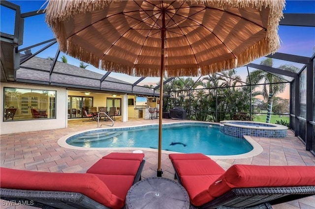 view of swimming pool with a lanai, a pool with connected hot tub, and a patio