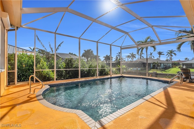 view of swimming pool featuring a lanai and a patio