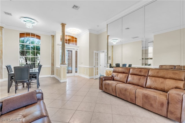 tiled living room with ornamental molding and decorative columns