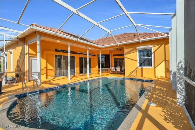 view of pool featuring a lanai, ceiling fan, and a patio