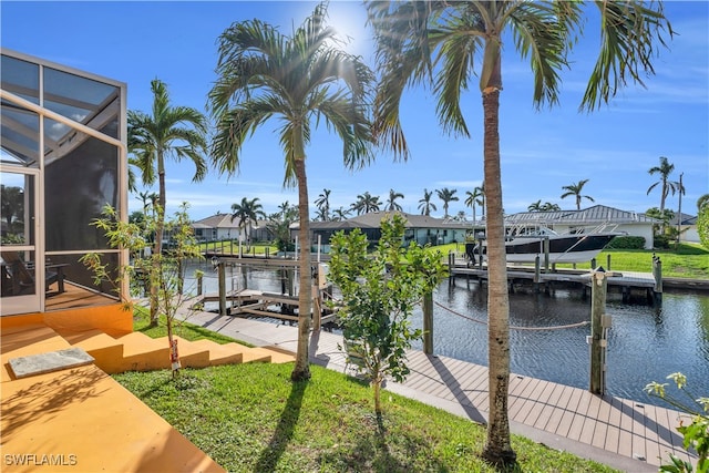 dock area with a lanai and a water view