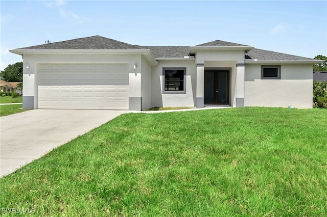 view of front of home featuring a front lawn and a garage