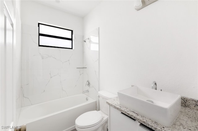 full bathroom featuring vanity, tiled shower / bath combo, and toilet