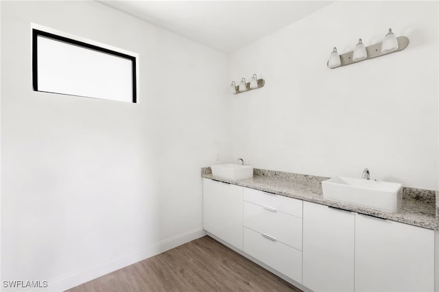 bathroom with vanity and hardwood / wood-style flooring