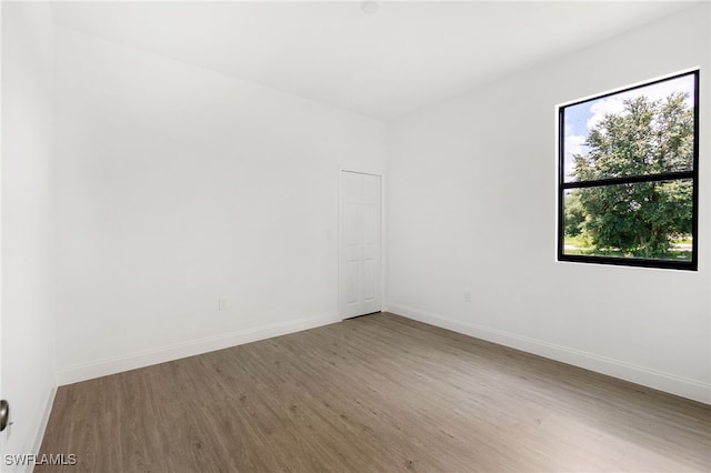 spare room with hardwood / wood-style flooring