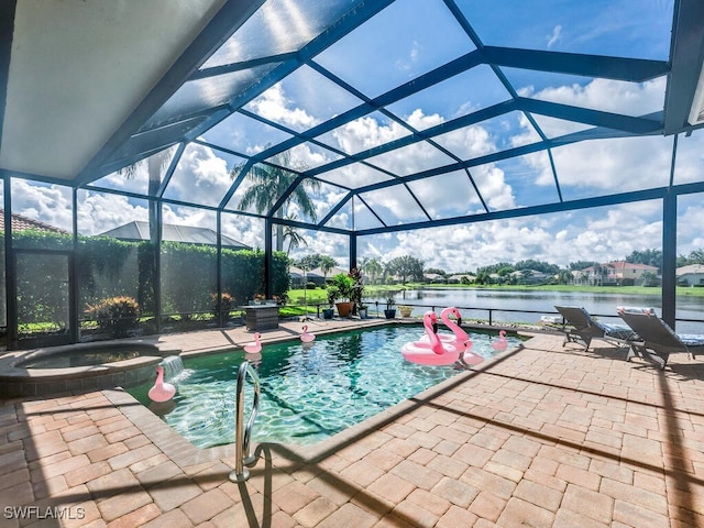 view of pool featuring an in ground hot tub, a patio, a water view, and glass enclosure