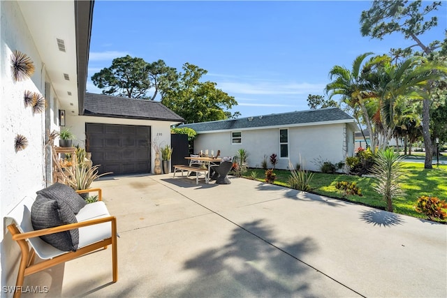 view of patio / terrace featuring a garage