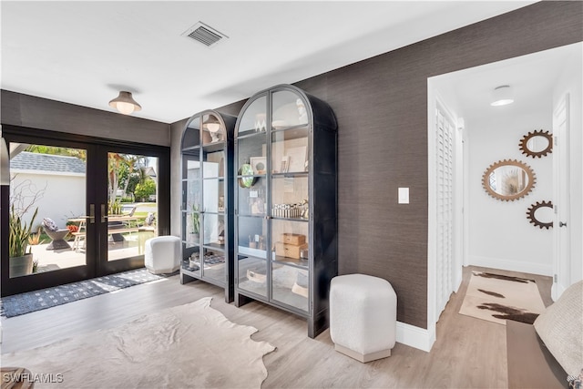 doorway to outside with light wood-type flooring and french doors