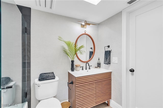 bathroom with vanity, toilet, and an enclosed shower