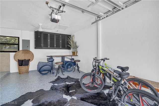 garage featuring a garage door opener, ceiling fan, and electric panel