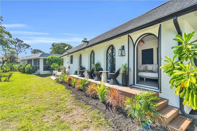 entrance to property featuring a lawn