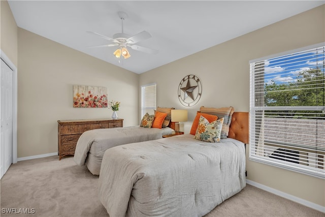 bedroom featuring a closet, light carpet, and ceiling fan