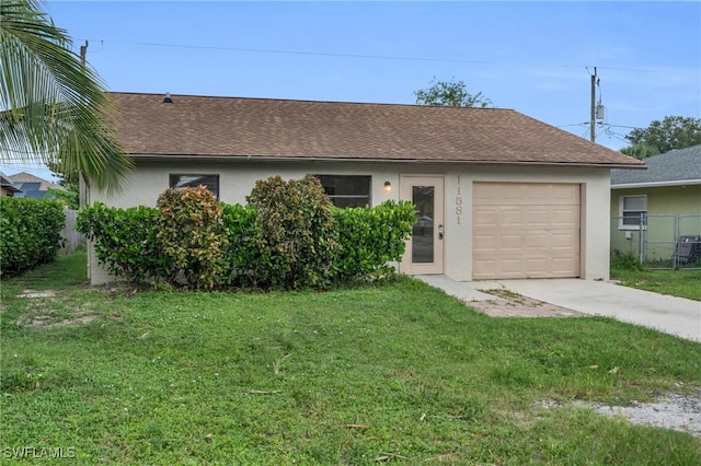 ranch-style home featuring a garage and a front yard