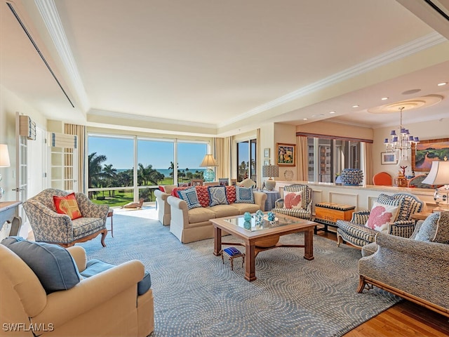 living room with ornamental molding, hardwood / wood-style floors, and a chandelier