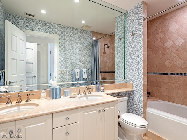 full bathroom featuring shower / tub combo, vanity, and toilet