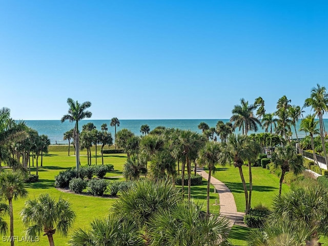 view of community with a lawn and a water view