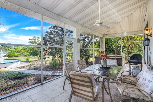 sunroom featuring ceiling fan and vaulted ceiling