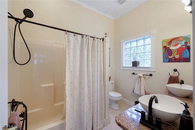 full bathroom featuring a textured ceiling, tile patterned flooring, shower / bath combination with curtain, and sink