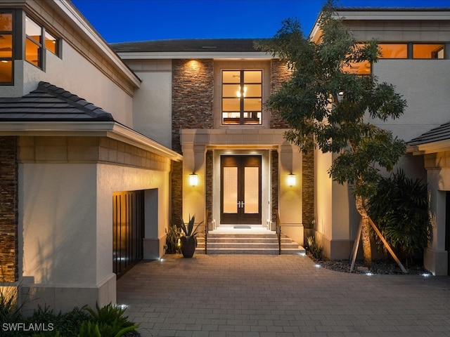 view of exterior entry featuring french doors