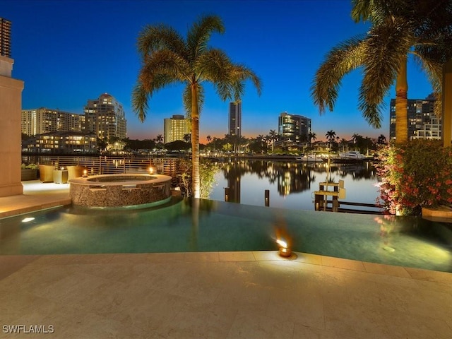 319 Devils Bight, Naples, FL 34103 - view of pool featuring a water view, a city view, and a pool with connected hot tub