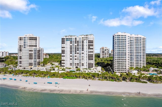 drone / aerial view featuring a water view and a beach view