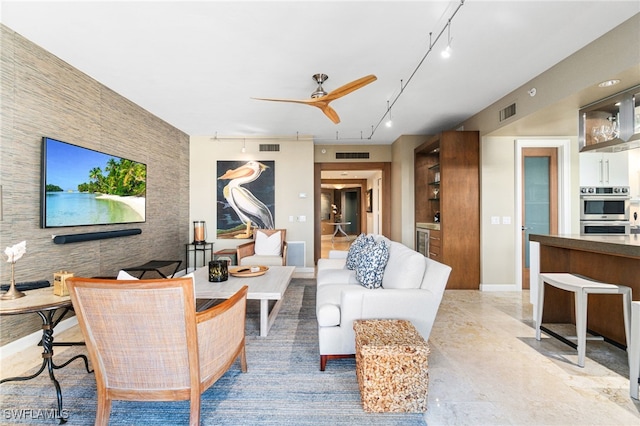 living room featuring ceiling fan and rail lighting