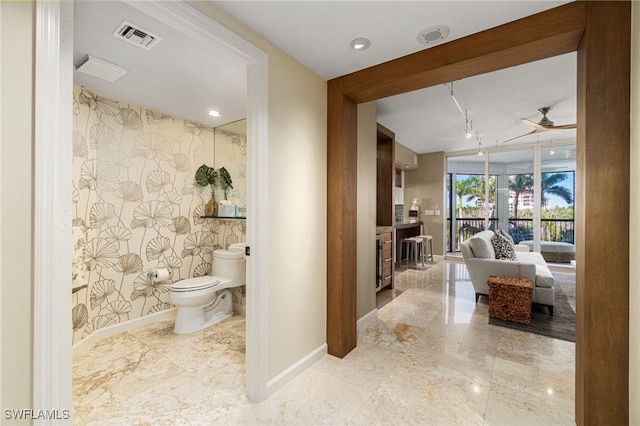 bathroom with ceiling fan and toilet