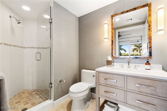 bathroom with tile patterned floors, vanity, toilet, and a shower with door