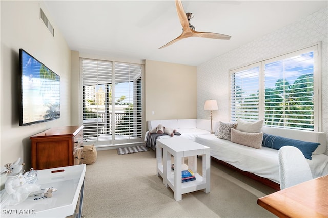 living room with light carpet and ceiling fan