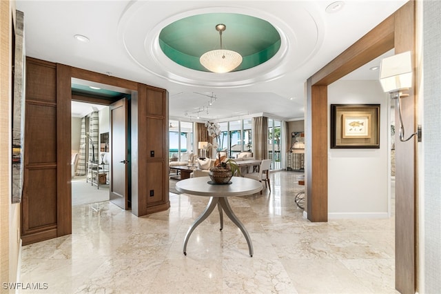 entryway featuring a tray ceiling